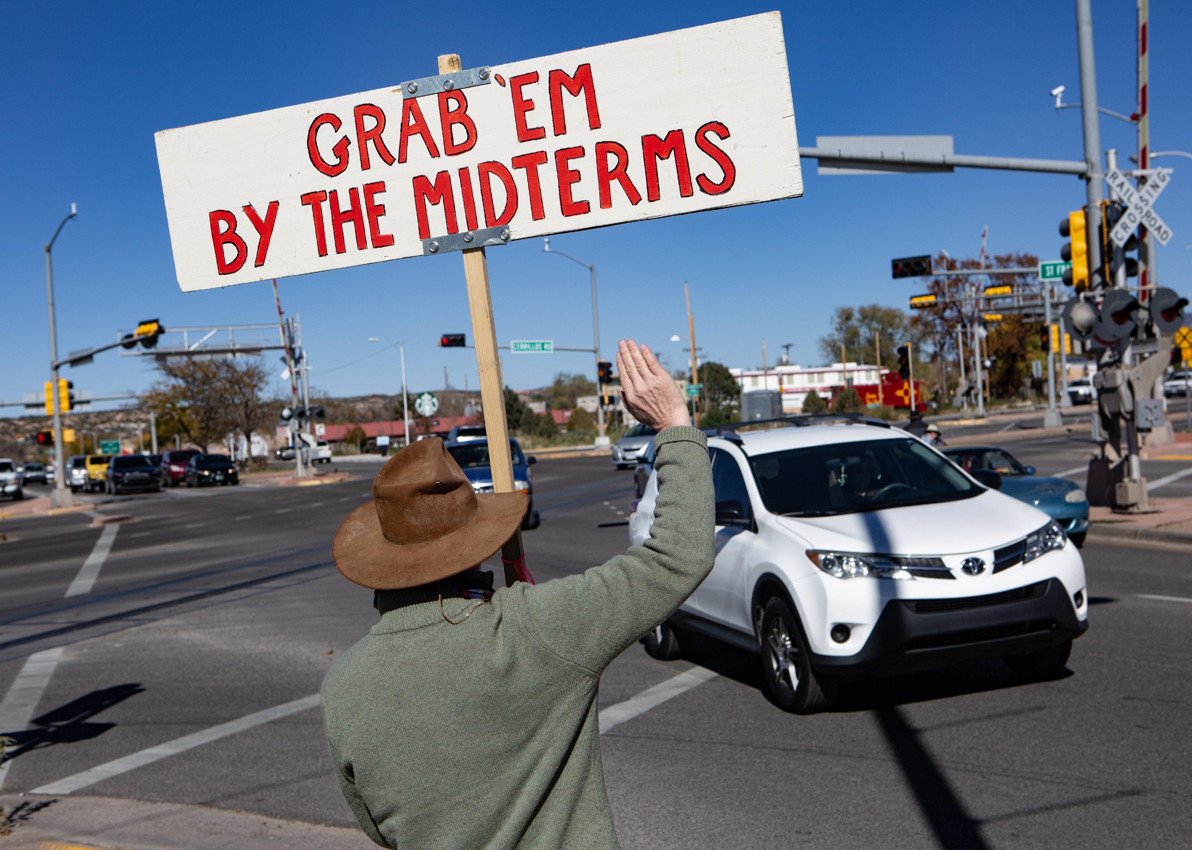 Activists at a intersection in Santa Fe, New Mexico, call on people to vote in the mid-term elections