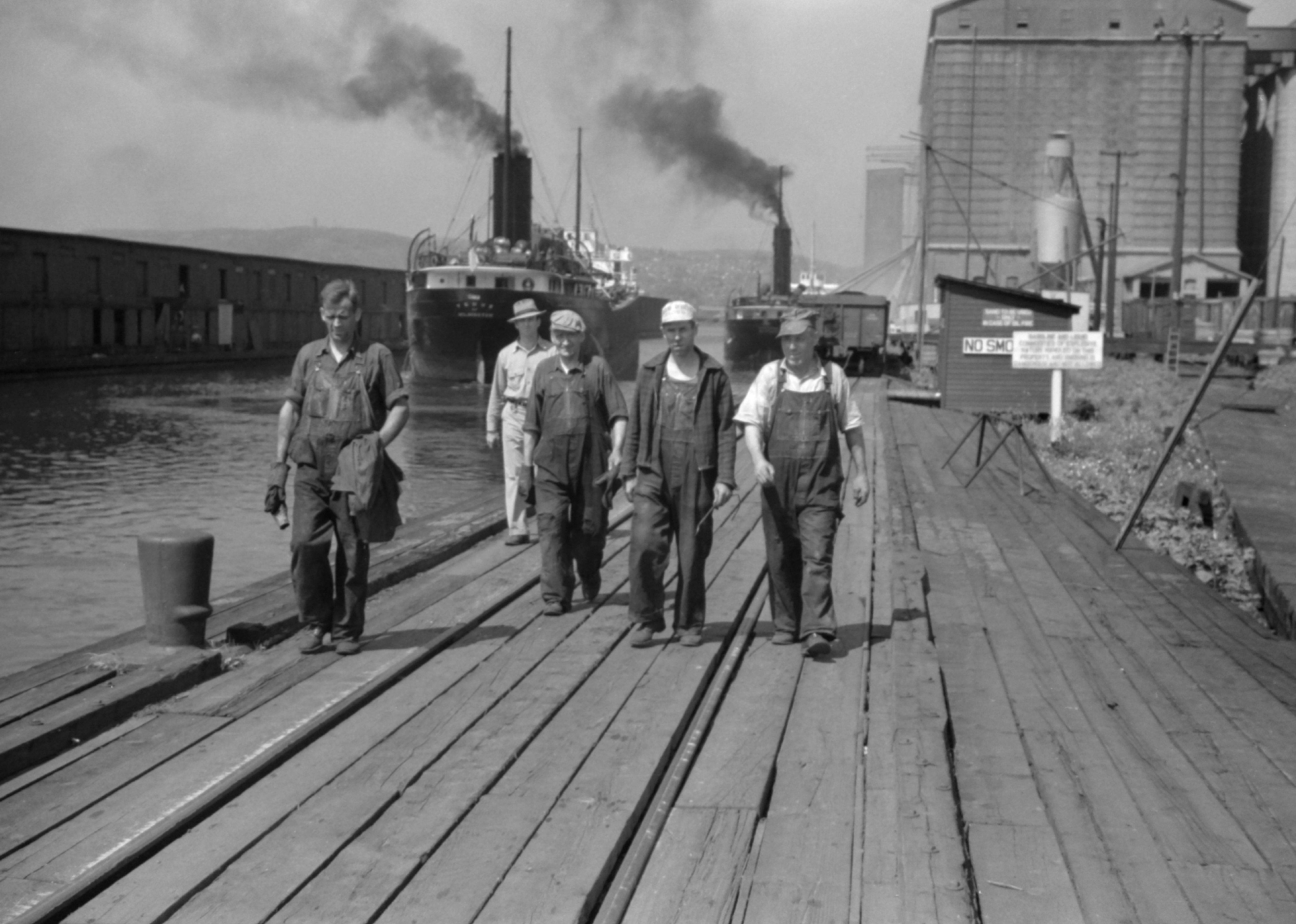 Workers walk along a dock in Superior, Wisconsin