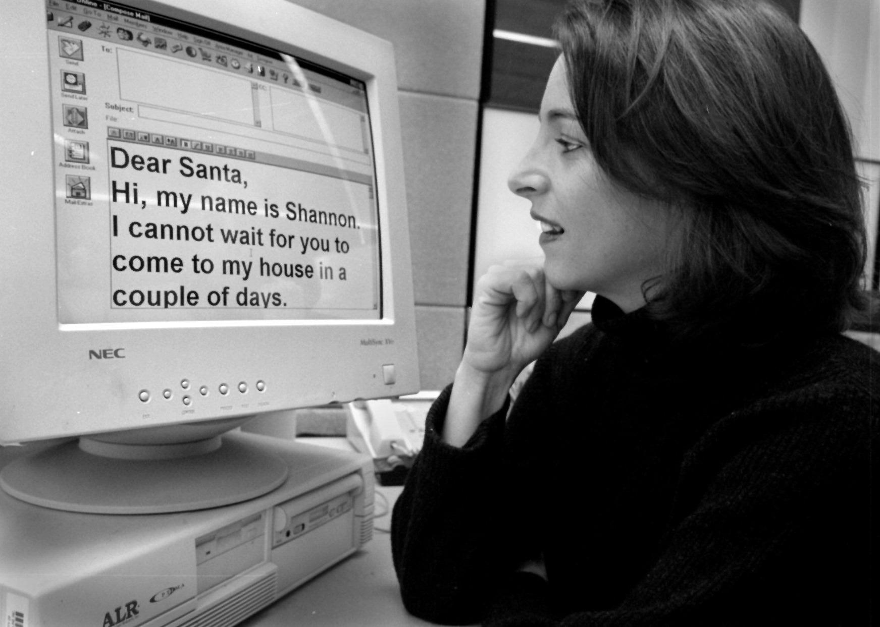 An employee at American Online with a Santa email on her computer