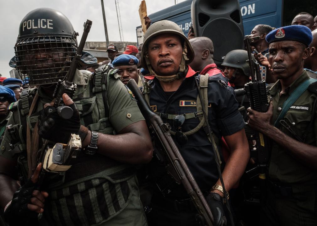 Nigerian police anti-riot unit secure the main gate of a local office