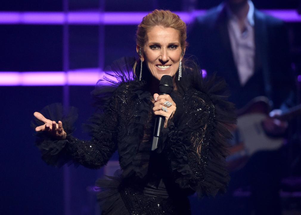 Celine Dion speaks on stage at a live event