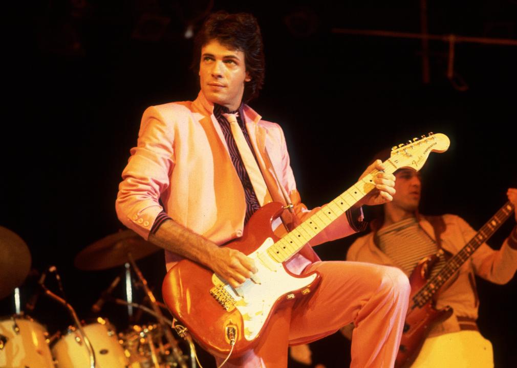 Rick Springfield plays guitar as he performs onstage at the Mill Run Theater.