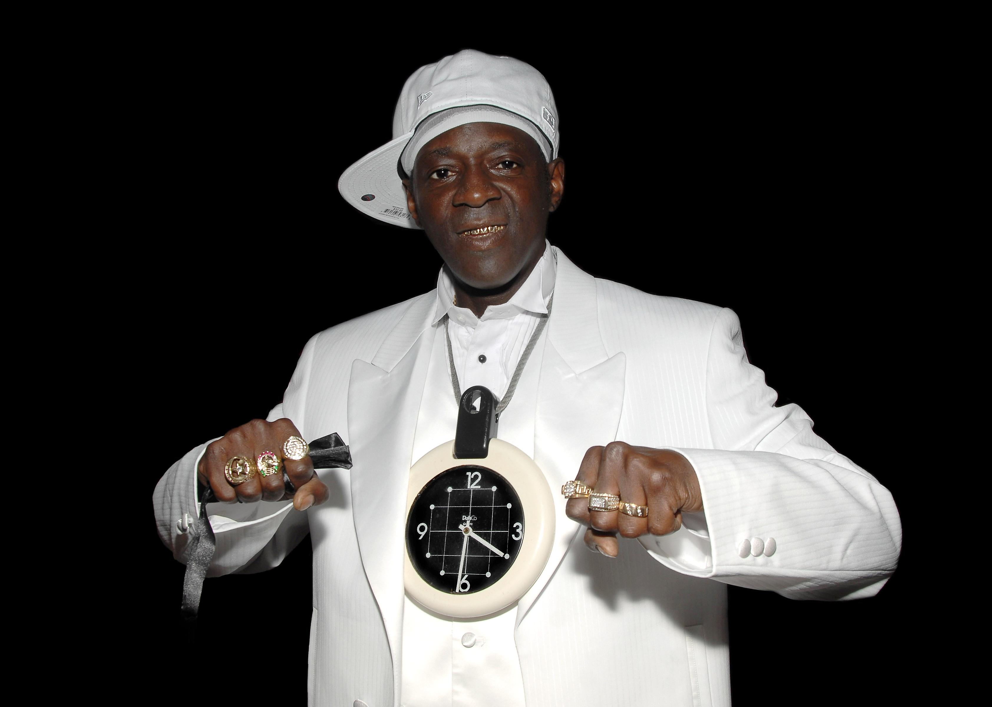 Flavor Flav signs copies of "Flavor Flav: The Icon The Memoir".