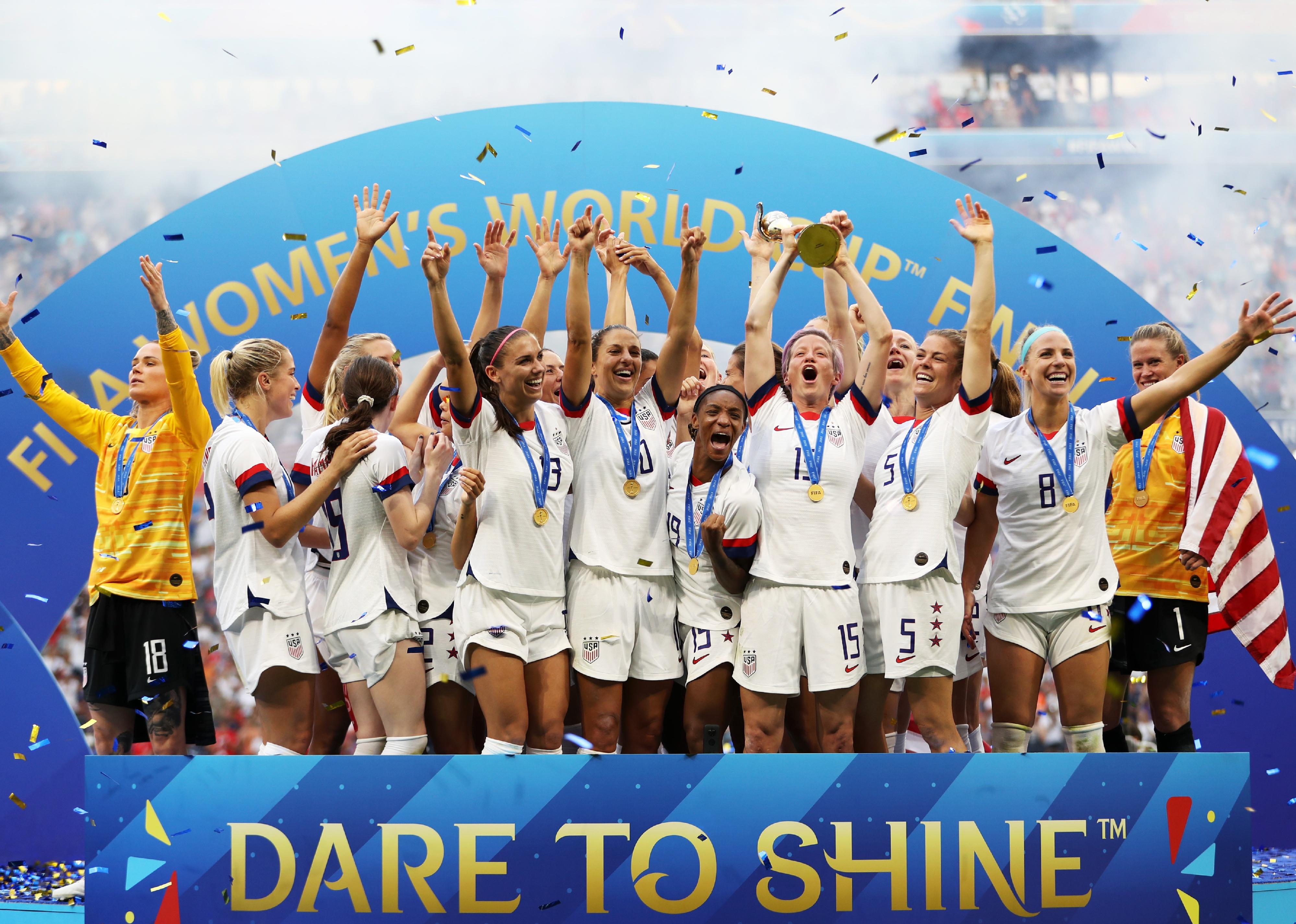 Players from U.S. lift the FIFA Women's World Cup Trophy following the team's victory during the 2019 FIFA Women's World Cup France Final match.