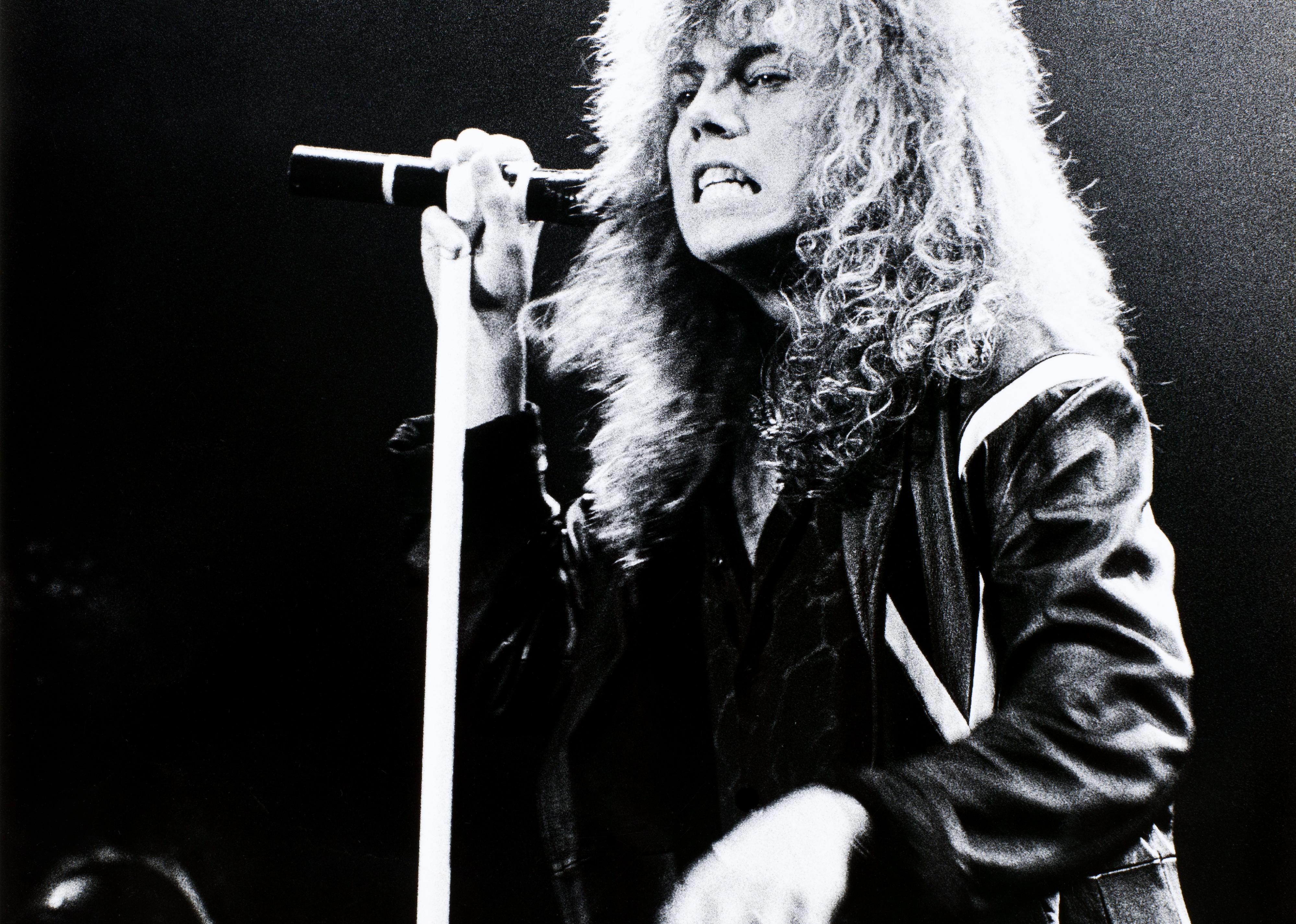 Joey Tempest of Europe performing on stage.