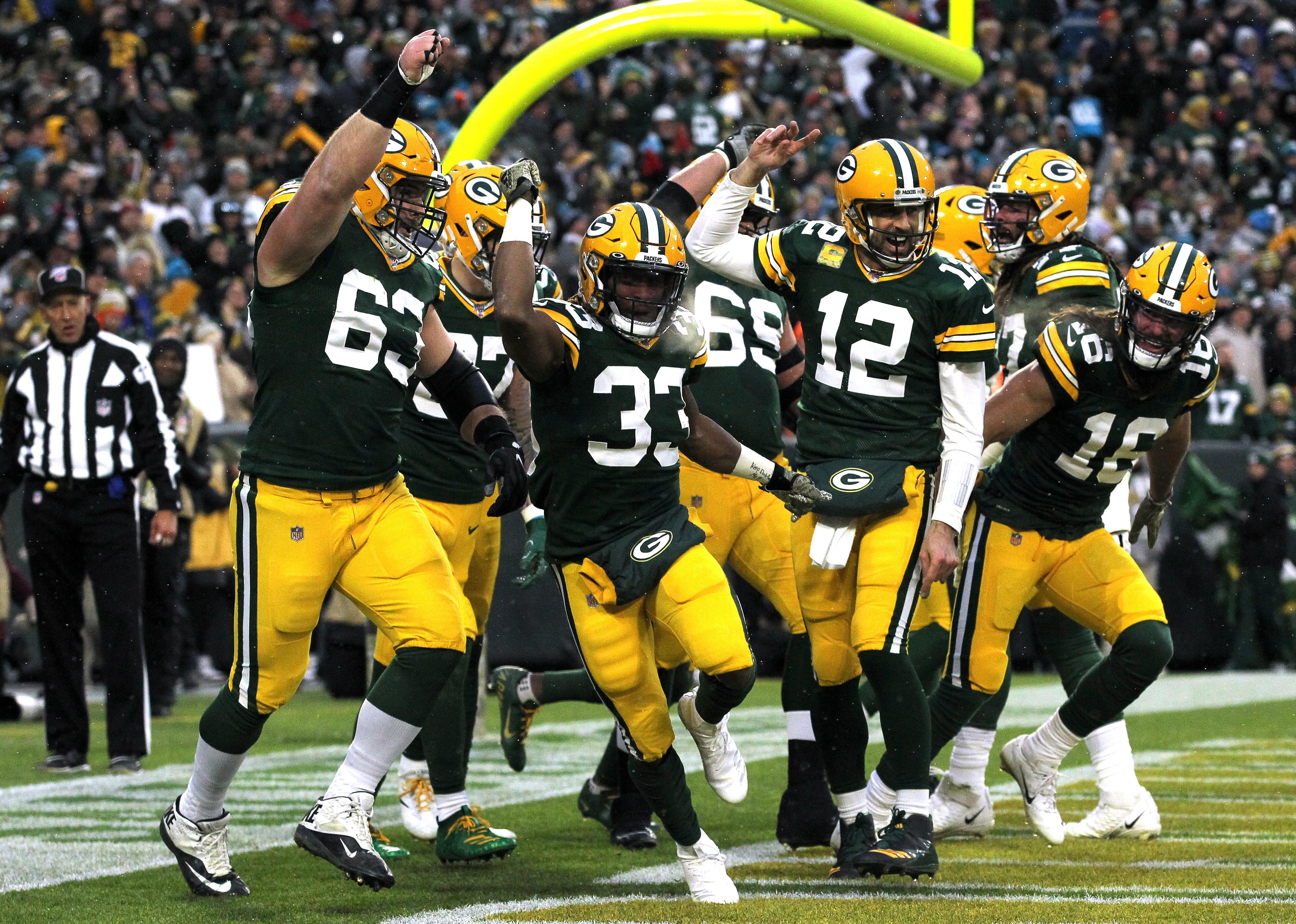 Aaron Jones of the Green Bay Packers celebrates with his teammates after scoring.