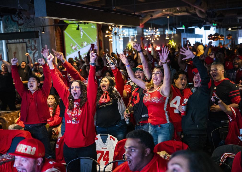 Fans react as they watch the San Francisco 49ers play the Kansas City Chiefs during Super Bowl LIV.