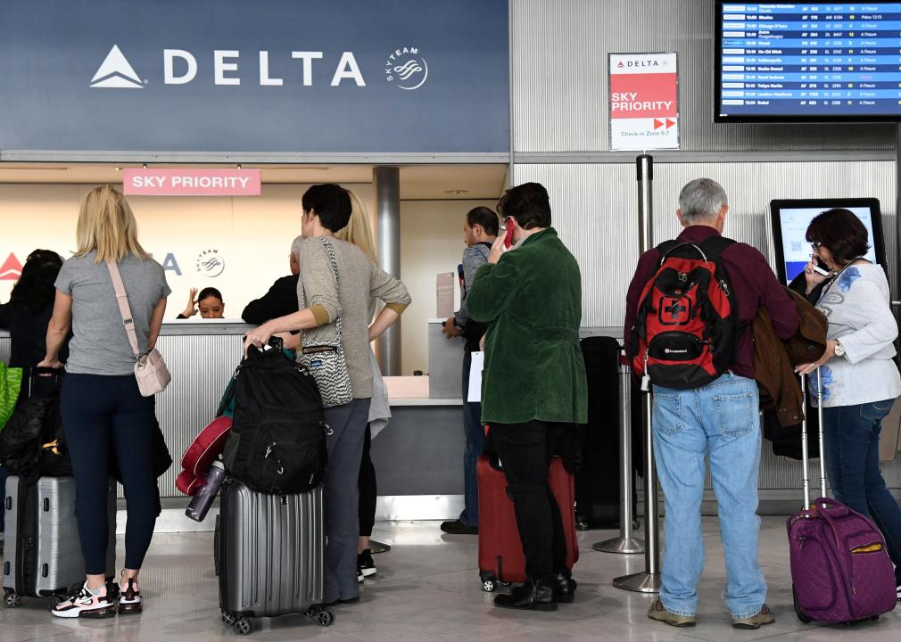 Travellers queue at a Delta Airlines desk at Paris-Charles-de-Gaulle airport.