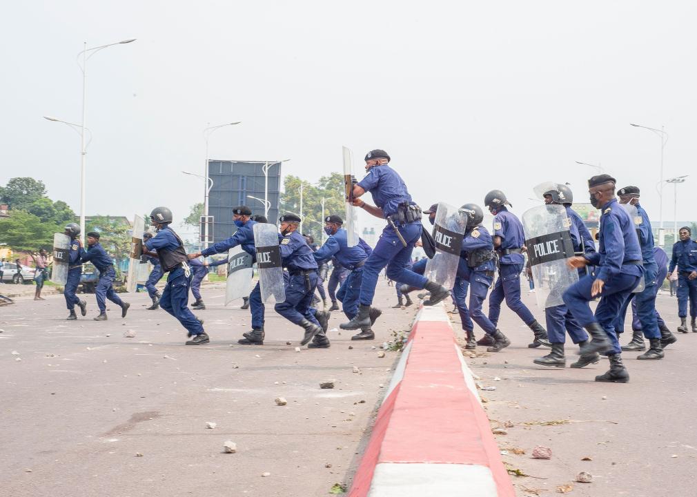 Police officers clash with demonstrators in Kinshasa