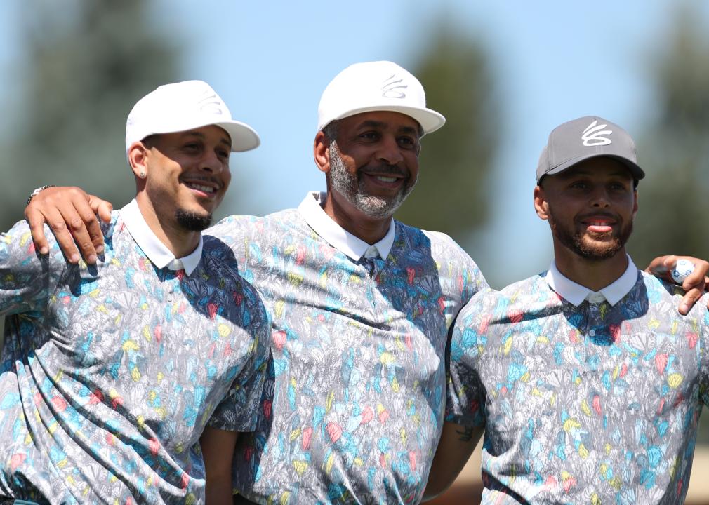 Seth Curry, Dell Curry, and Steph Curry pose for a picture.
