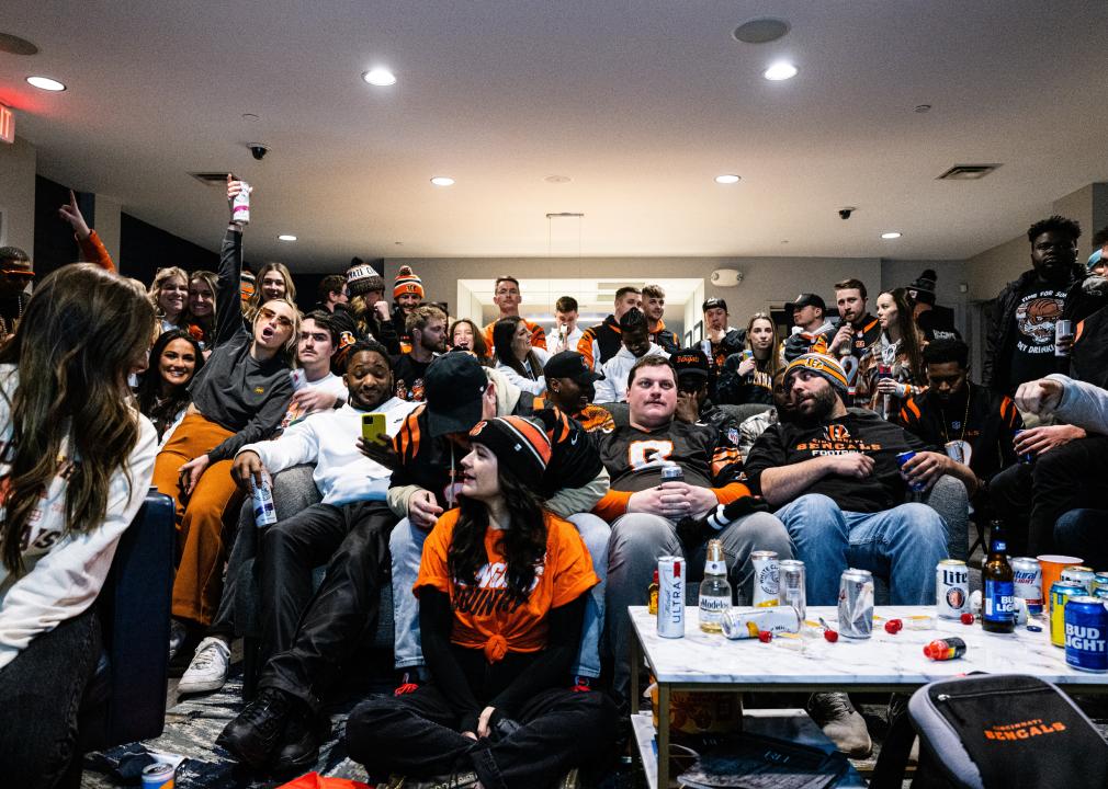 Bengals fans gather in a recreation room of an apartment building to watch the Super Bowl LVI.