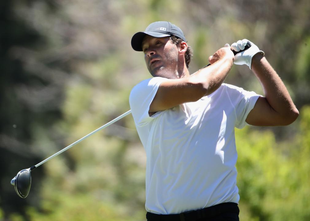 Tony Romo plays a tee shot on the ninth hole 