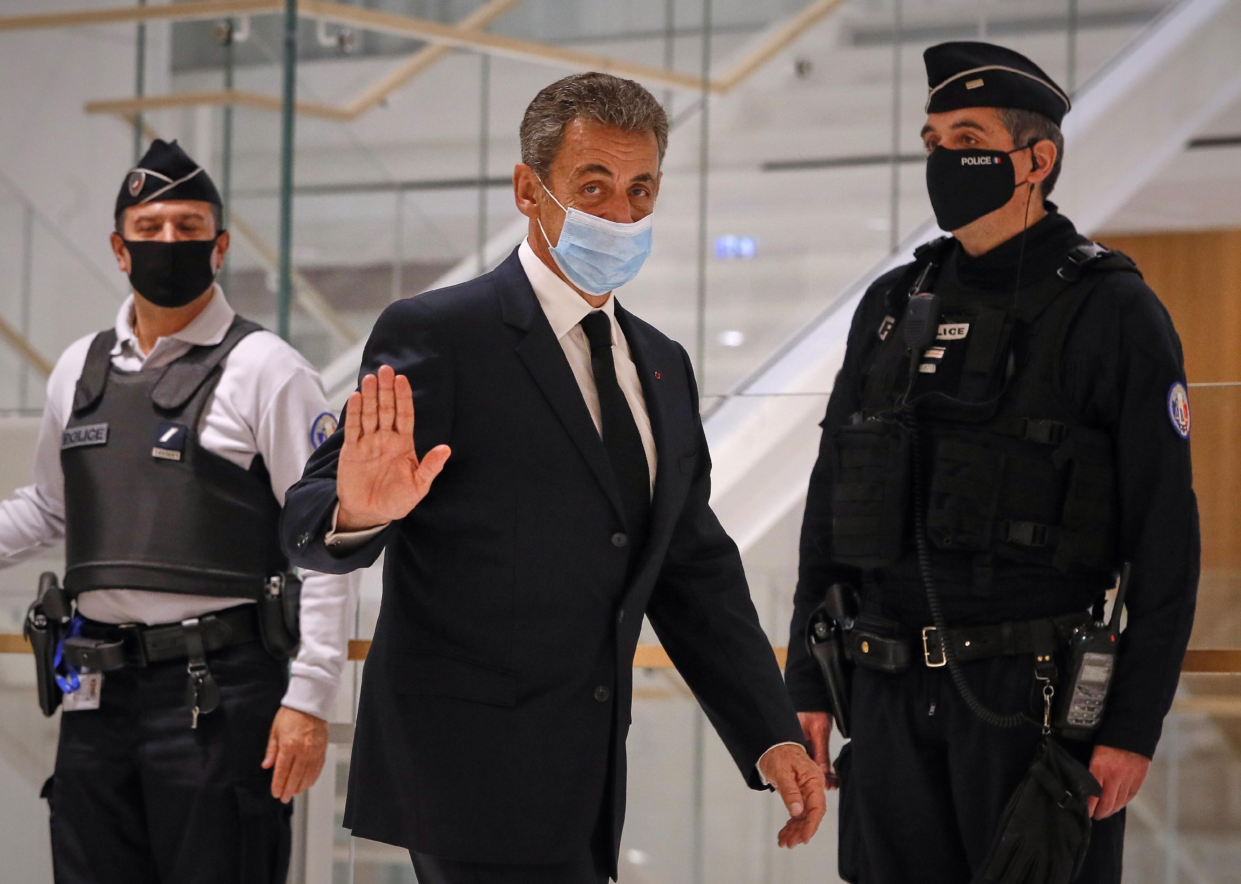 Nicolas Sarkozy leaves court after the second day of his trial 
