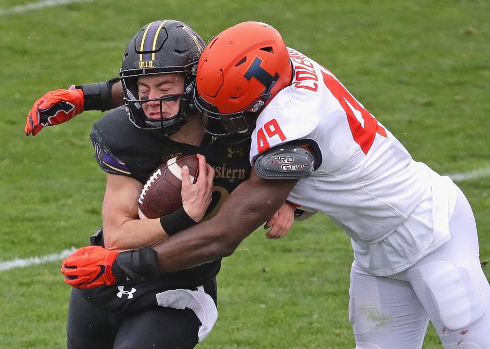 Peyton Ramsey of the Northwestern Wildcats is hit by Seth Coleman of the Illinois Fighting Illini 