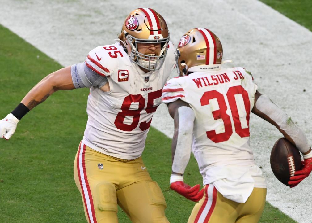 Jeff Wilson Jr. celebrates with tight end George Kittle of the San Francisco 49ers after a touchdown.