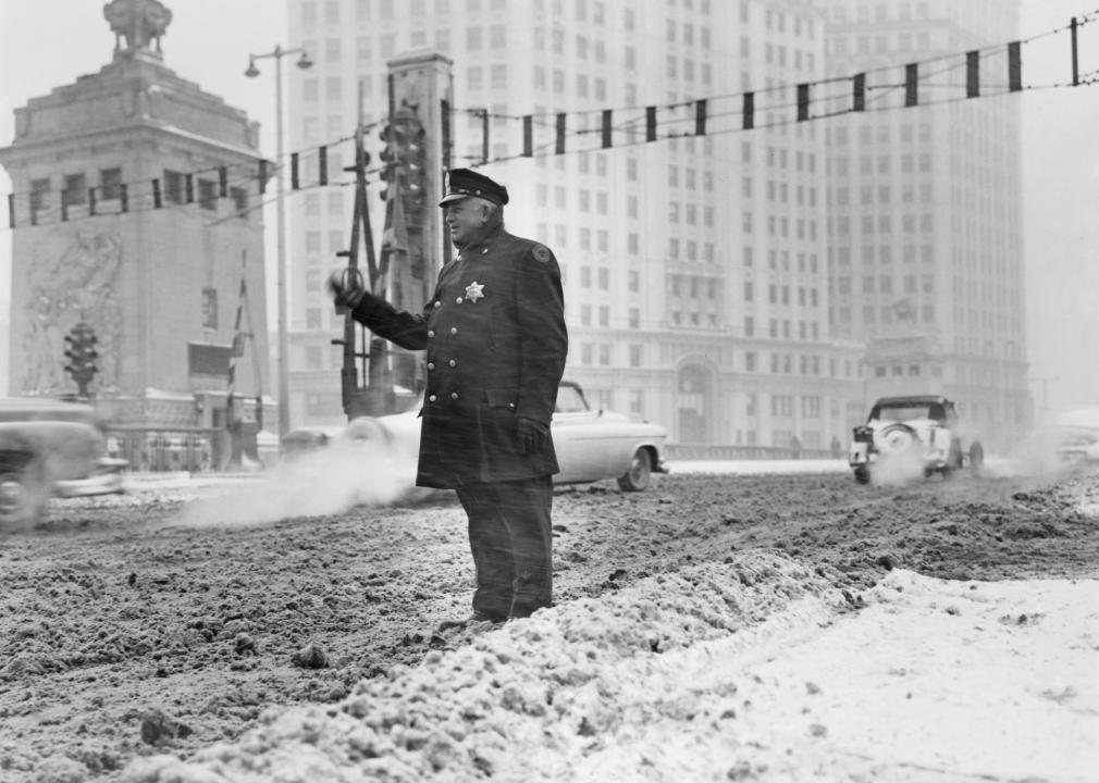 Patrolman standing in deep snow and motions 