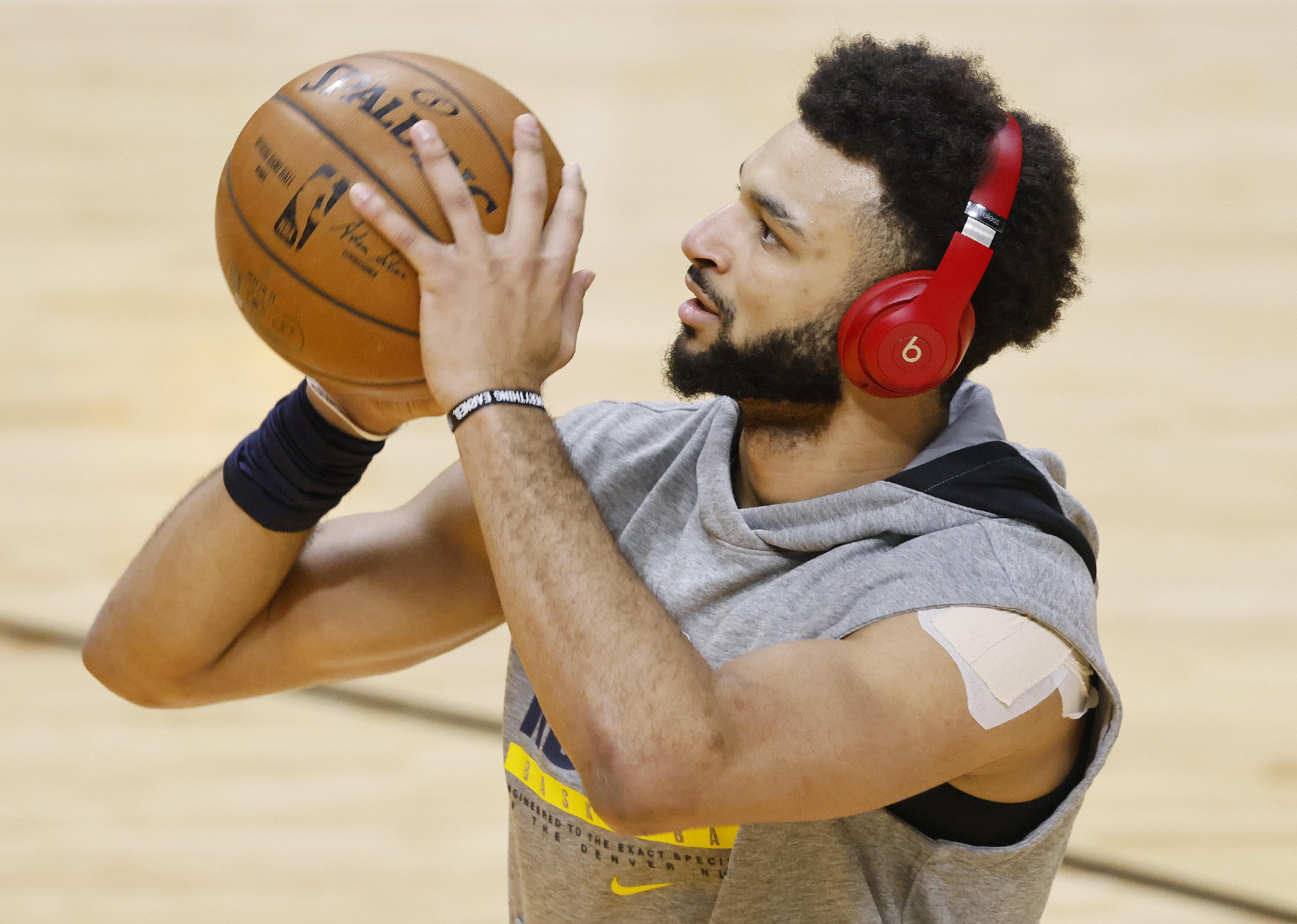 Jamal Murray of the Denver Nuggets warms up and wears a pair of Beats Headphones