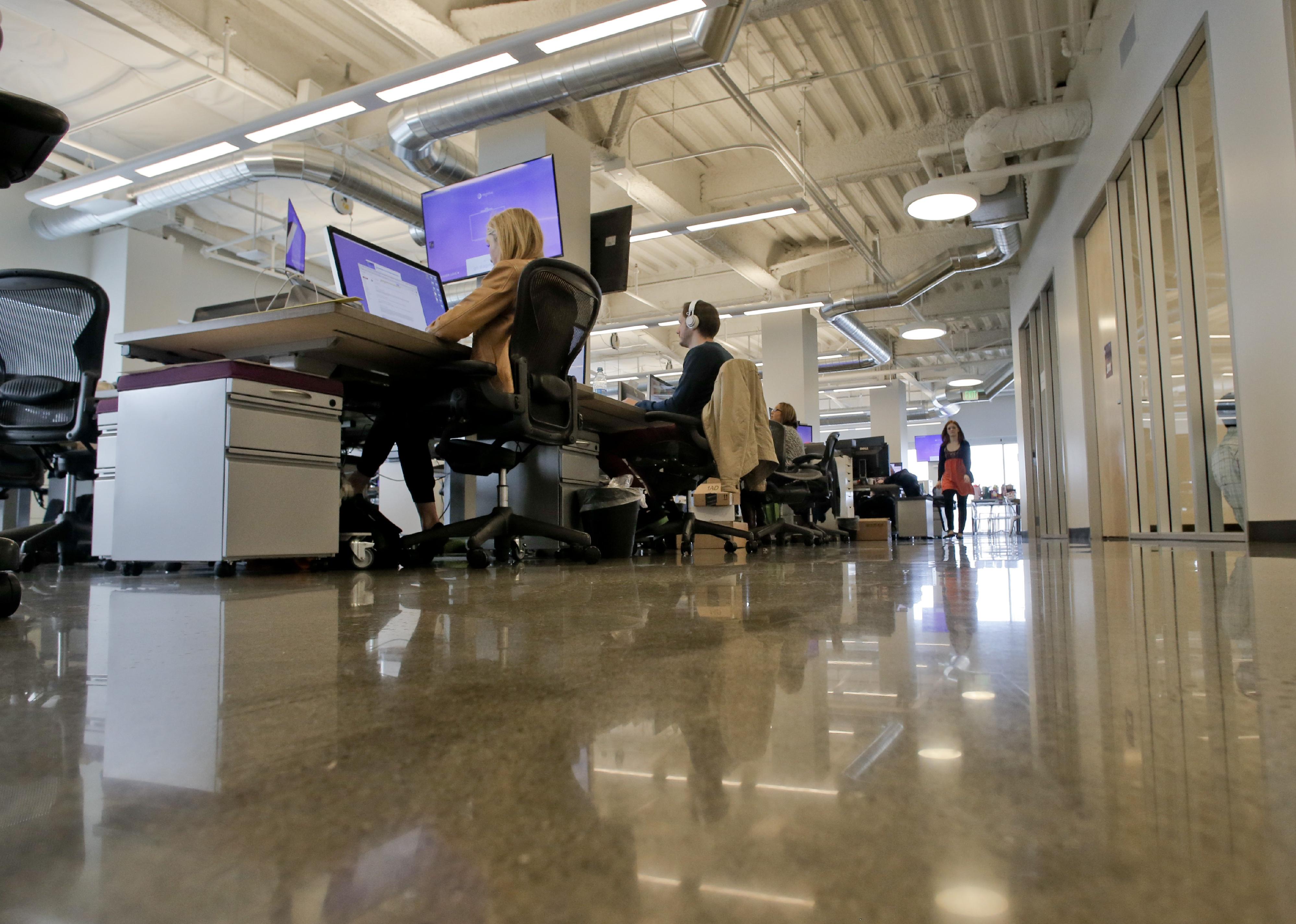 Employees at work inside the offices of Highfive in Redwood City