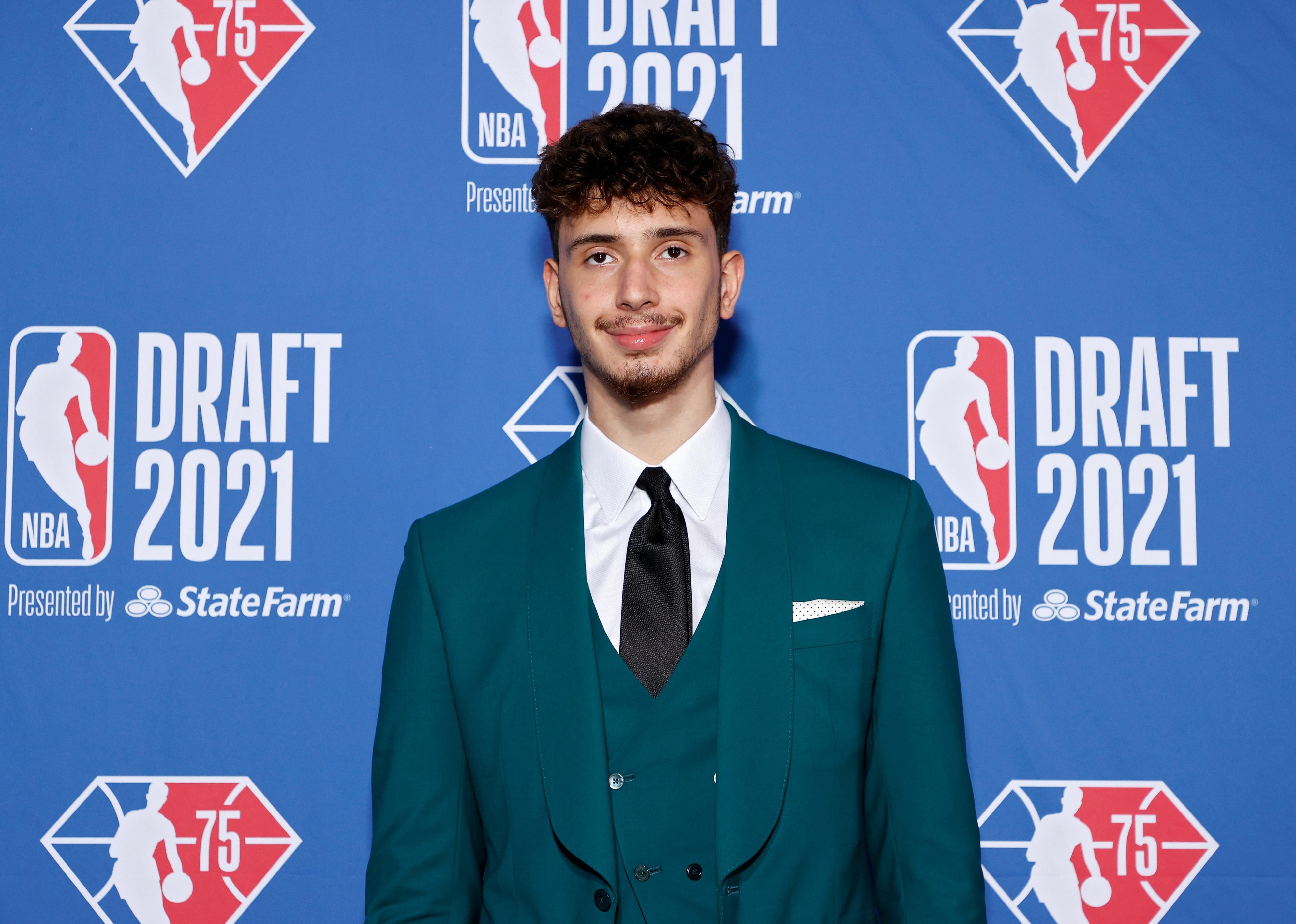 Alperen Sengun poses for photos on the red carpet during the 2021 NBA Draft.