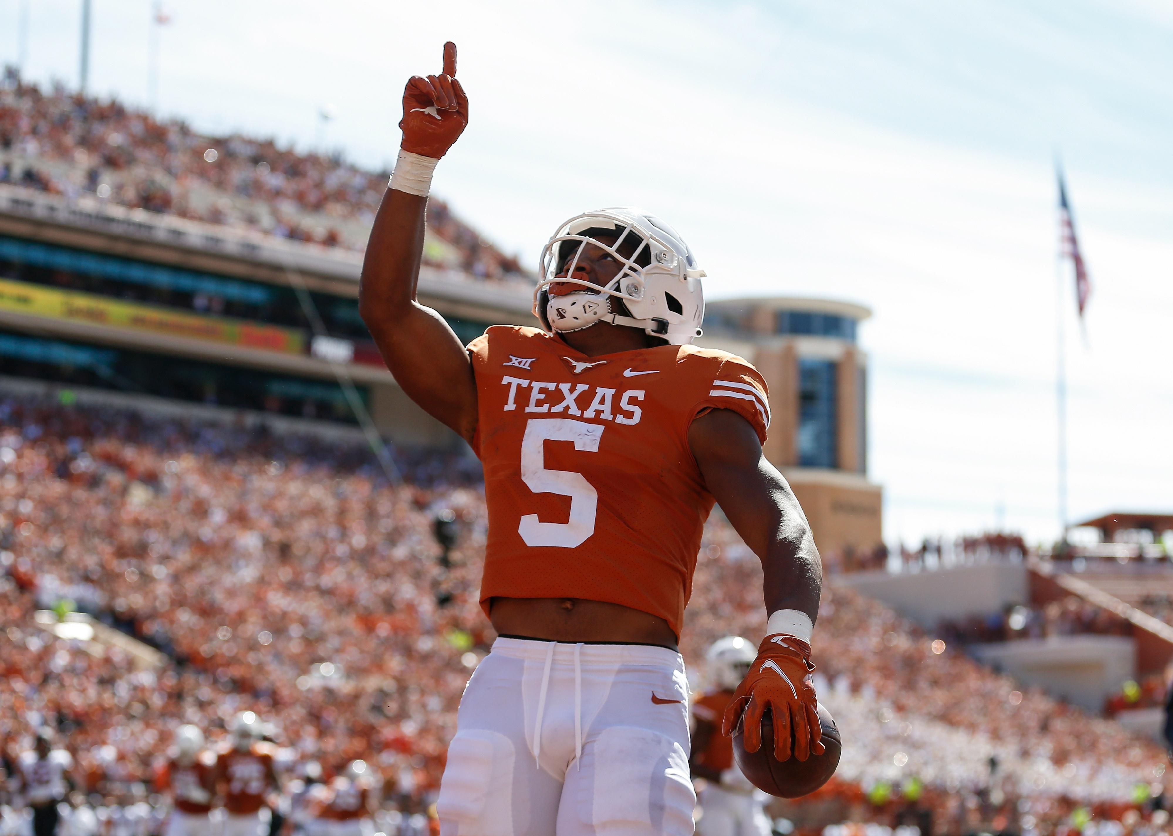 Bijan Robinson of the Texas Longhorns reacts after a touchdown.