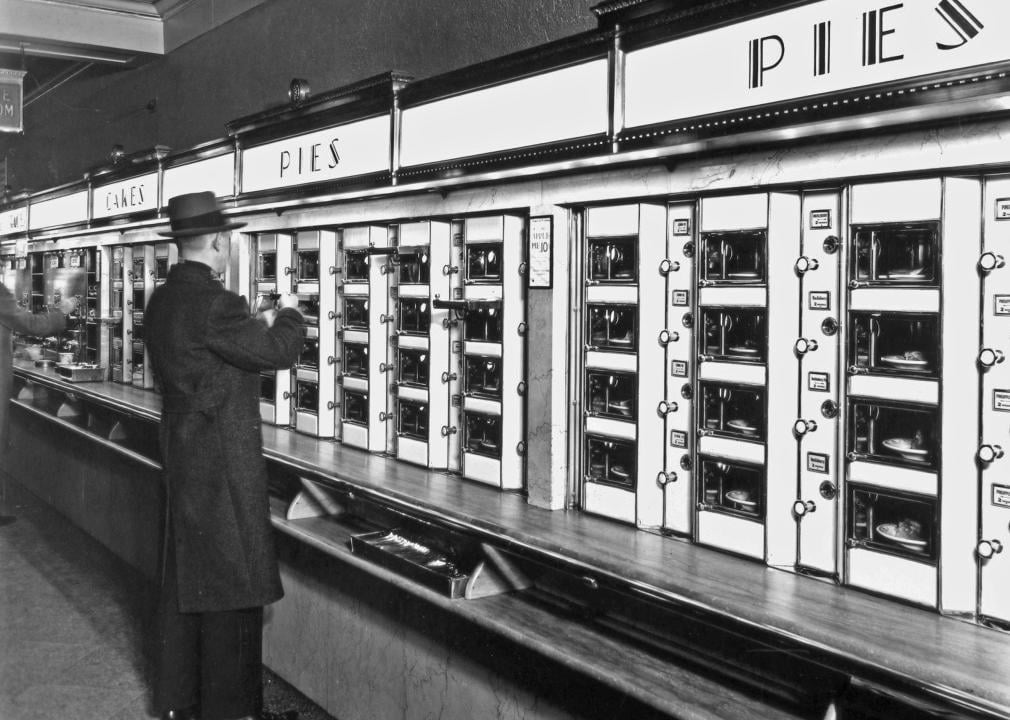 Man taking a pie from an automat.