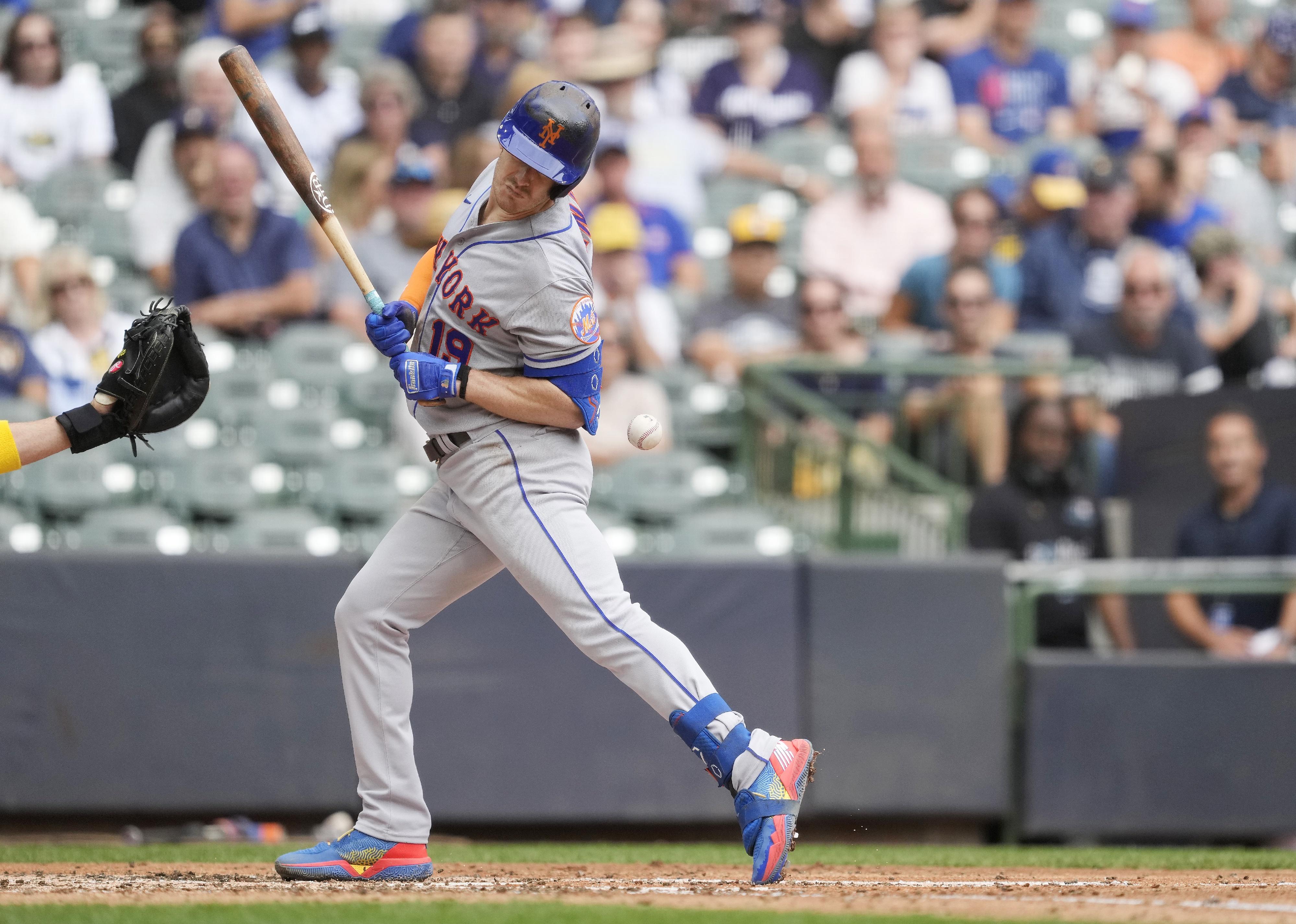 Mark Canha of the New York Mets is hit by a pitch.