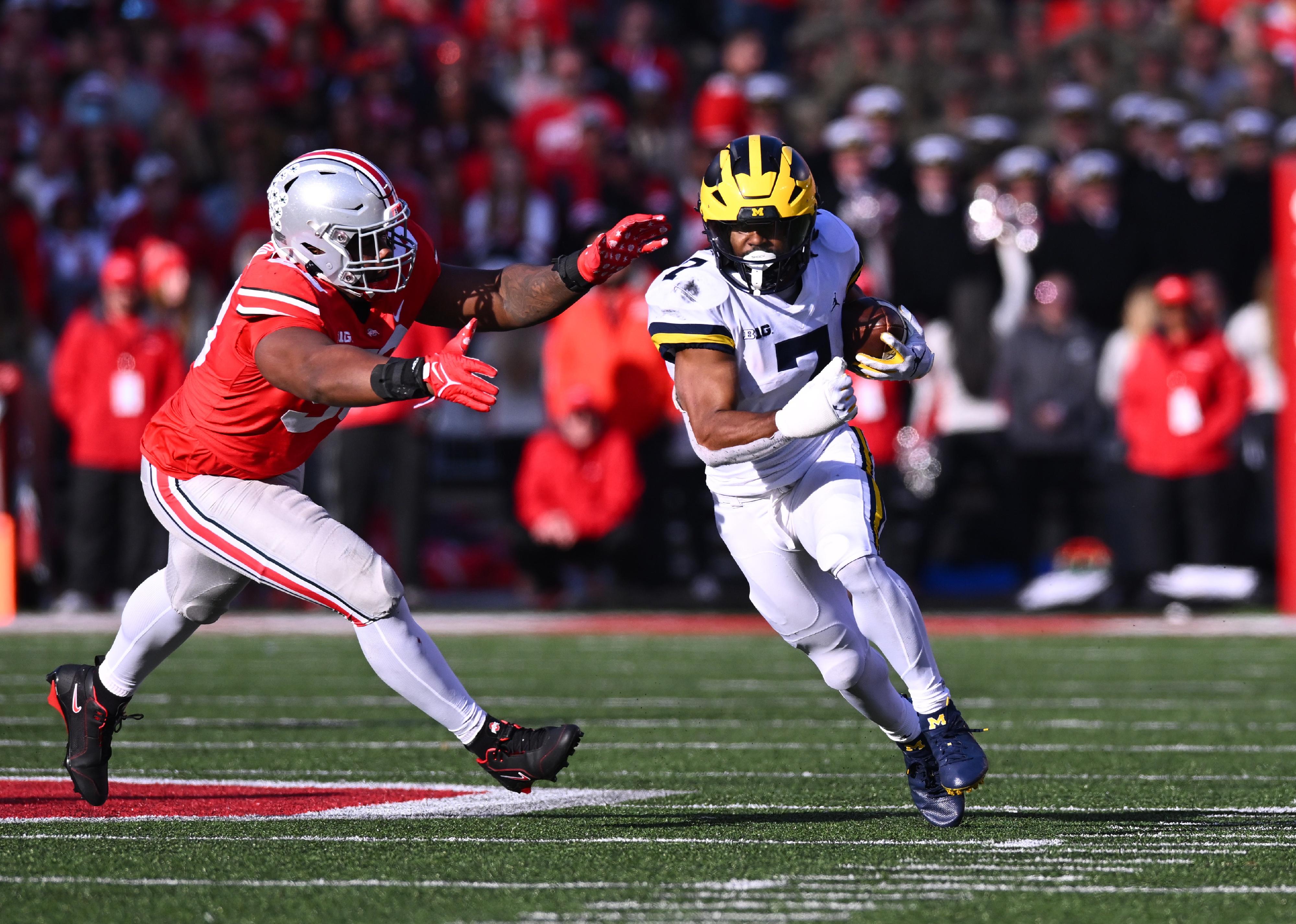 Donovan Edwards of the Michigan Wolverines runs with the ball during a game against the Ohio State Buckeyes.
