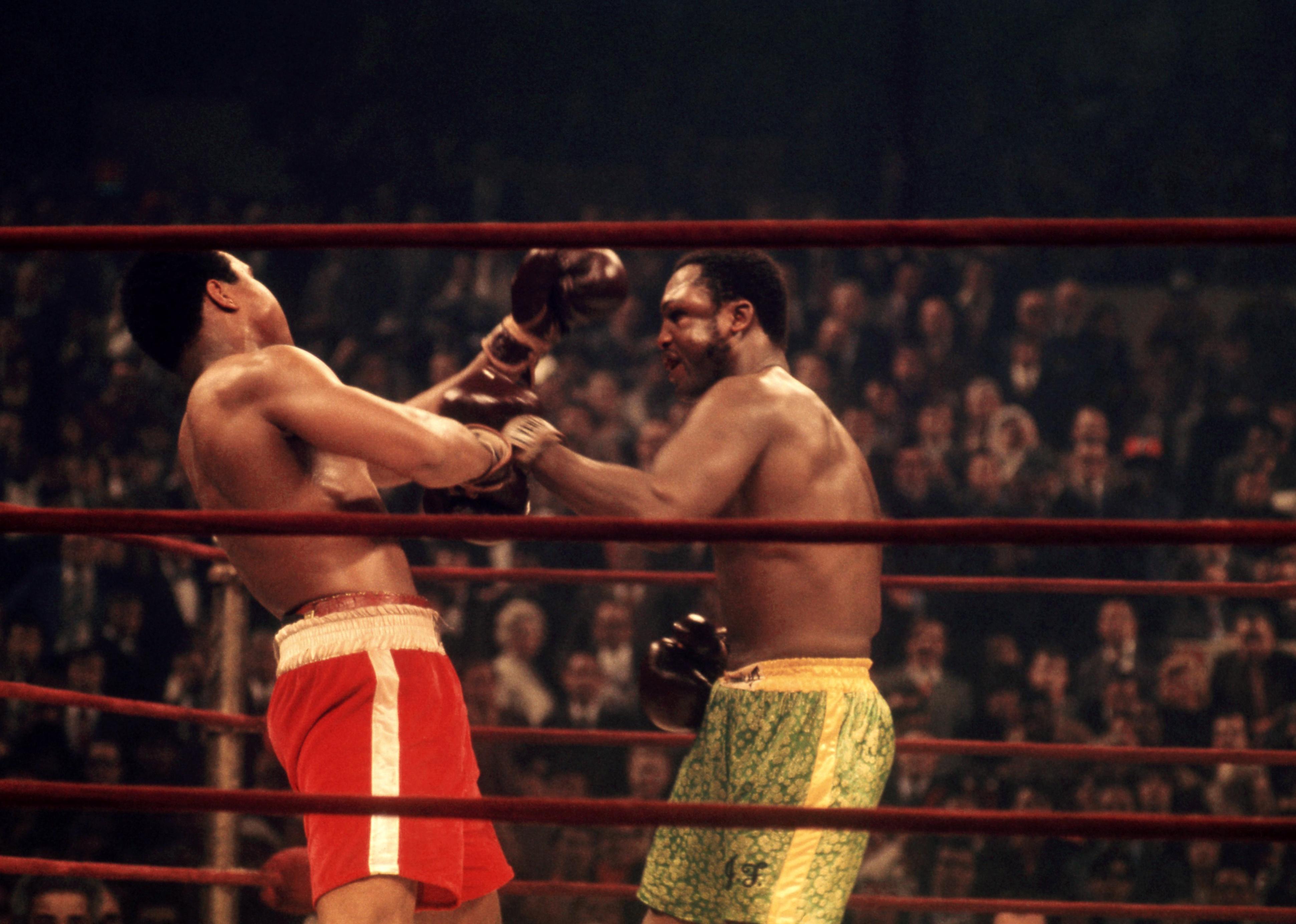 Muhammad Ali takes a punch from Joe Frazier during their 