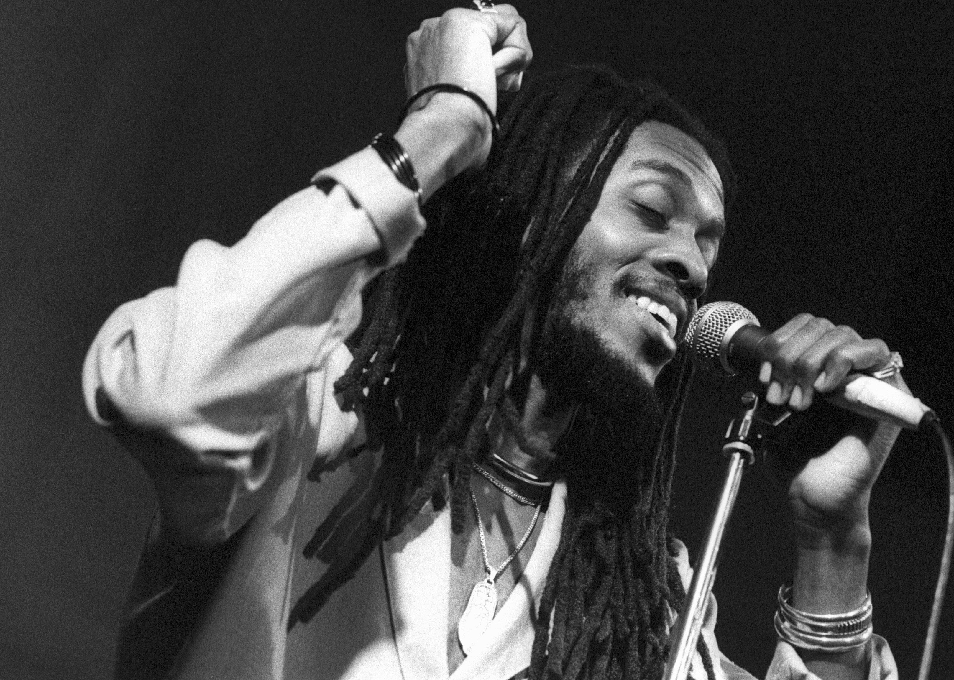Ini Kamoze performs live on stage.