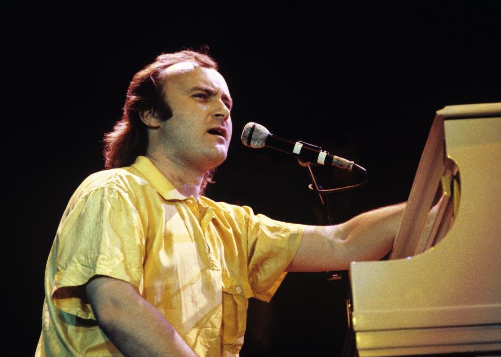 Phil Collins behind a piano.