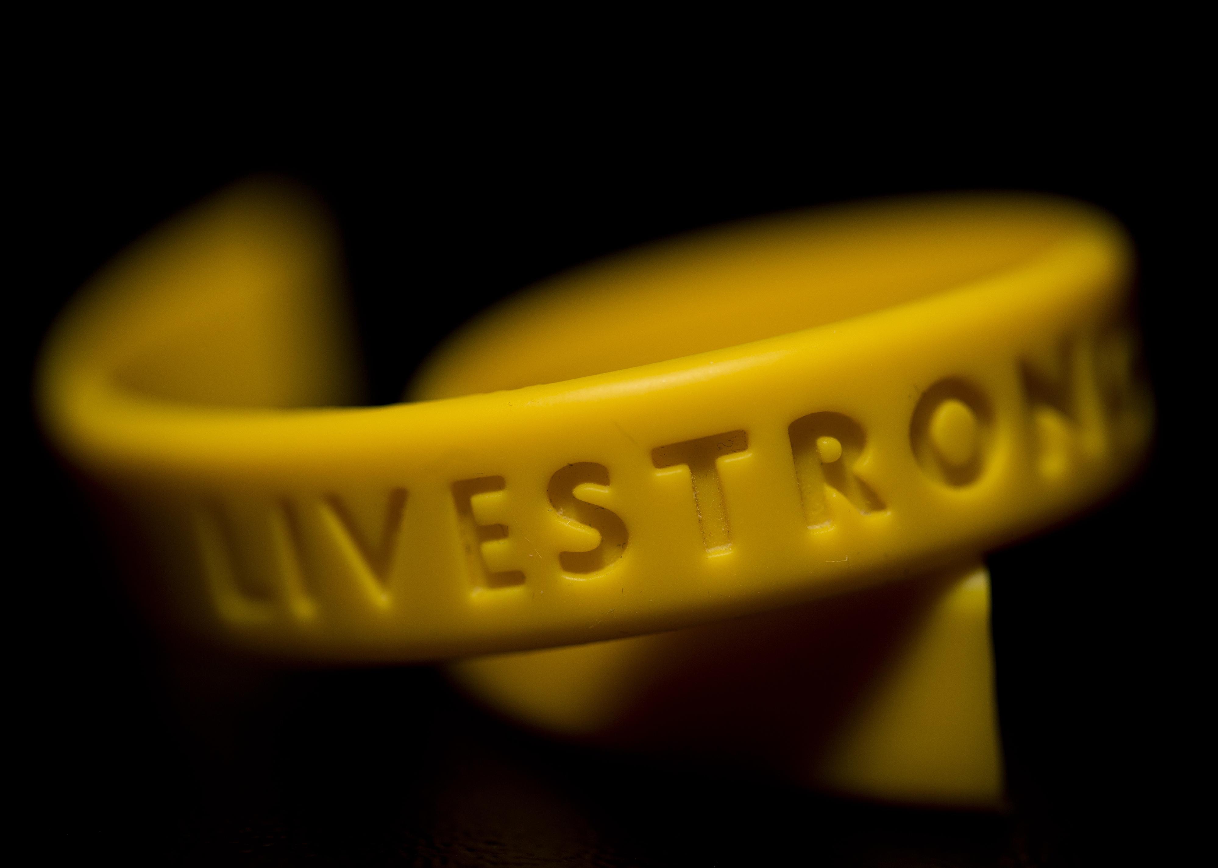 Close-up of a yellow silicone gel Livestrong wristband.