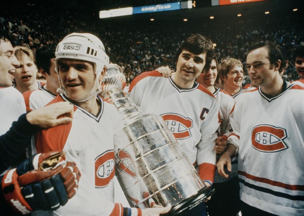 Jacques Lemaire and other players celebrate with the Stanley Cup