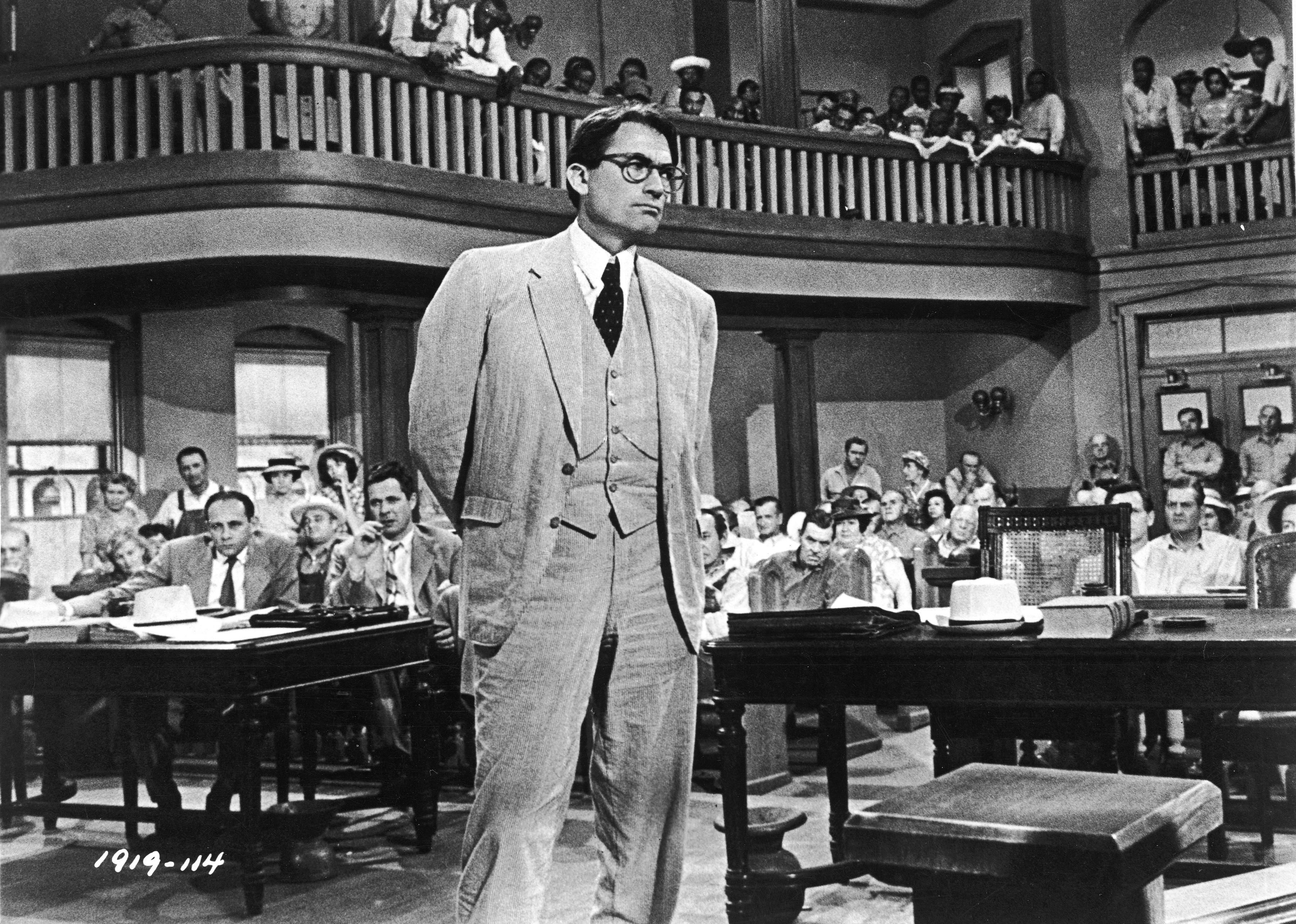 Gregory Peck, as Atticus Finch, stands in a courtroom in a scene from To Kill A Mockingbird.