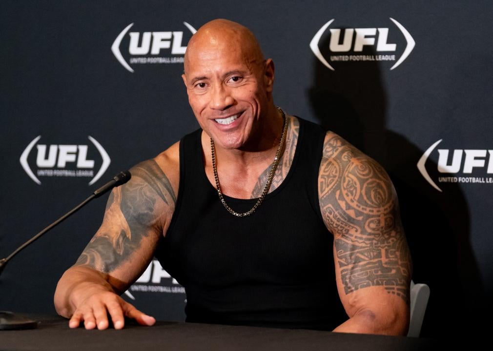 Dwayne Johnson, The Rock, smiles during a press conference during a UFL game.