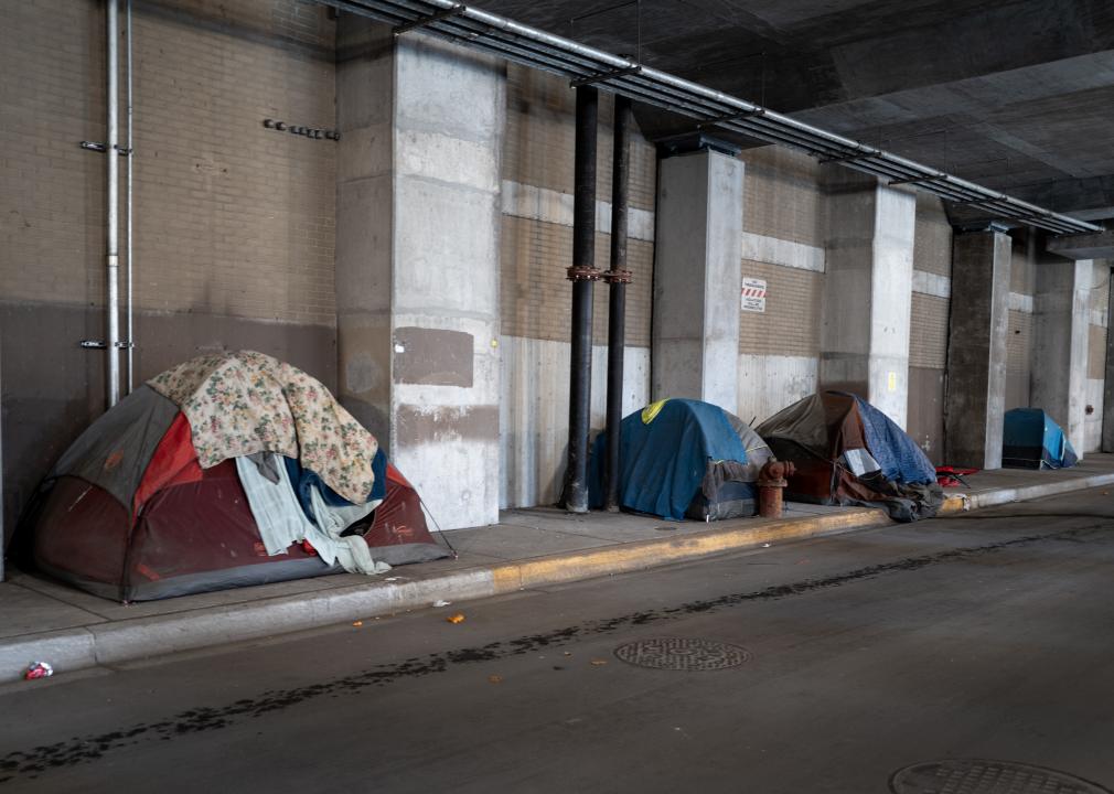 Tents used by the unhoused people sit along a sidewalk in downtown Chicago.