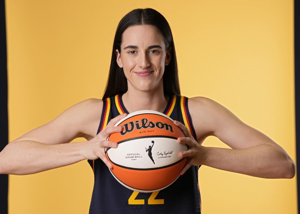 Caitlin Clark of the Indiana Fever poses for a photo while holding a basketball.