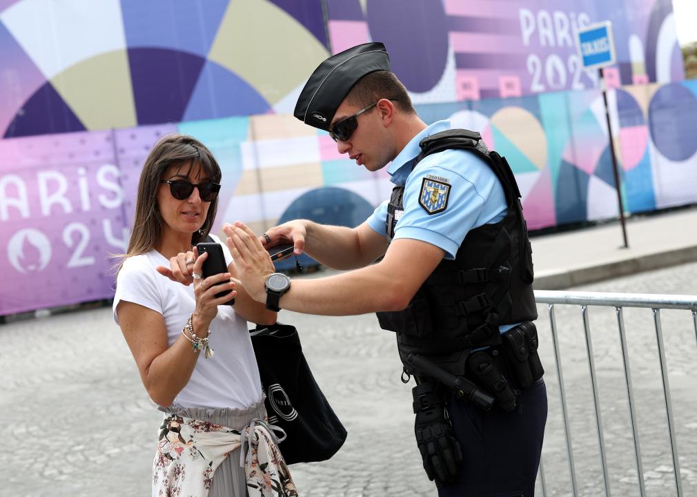 People show their QR access code to get into the Olympics.