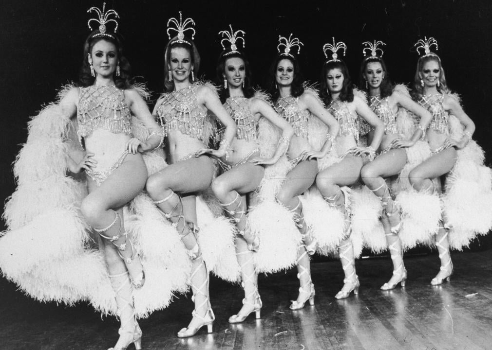 The Rockettes lined up in formation with elaborate costumes.