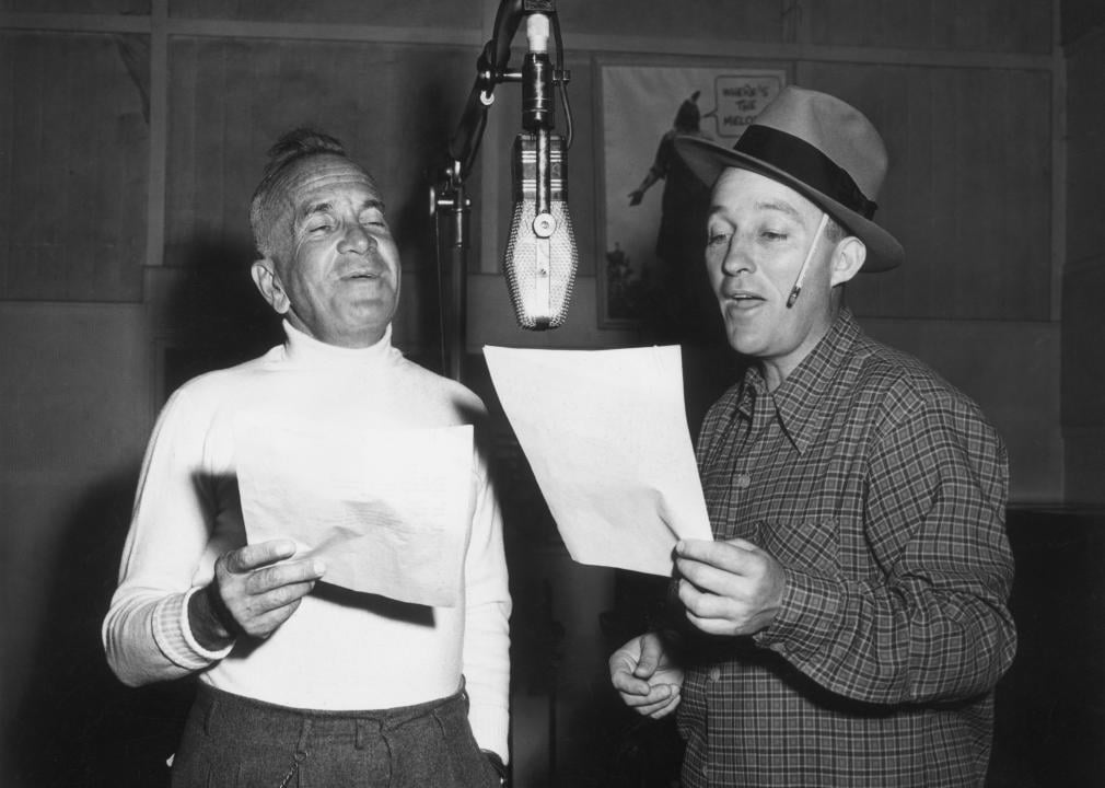 Bing Crosby sings in a recording studio.