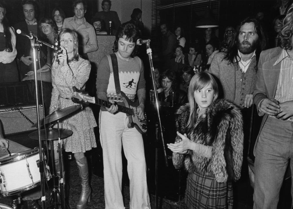 Paul McCartney and his wife Linda perform with their pop group Wings.