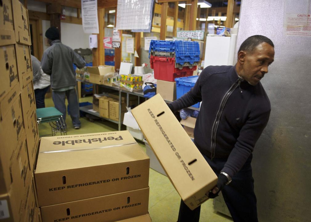 Workers unload boxes of frozen turkeys ahead of Thanksgiving at Bread for the City.