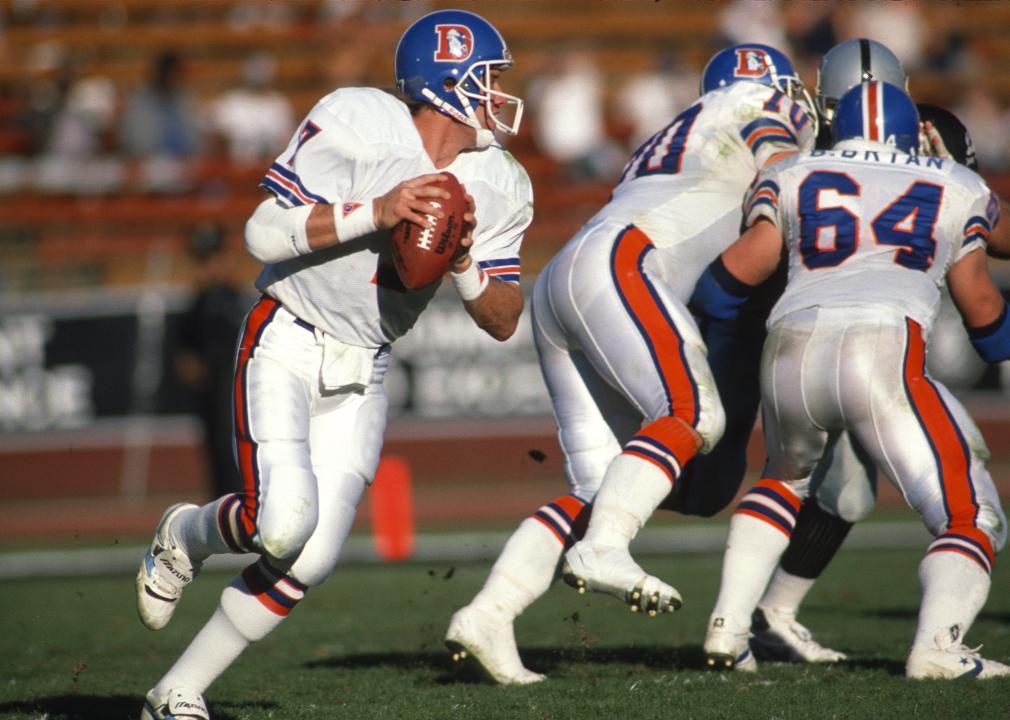 John Elway of the Denver Broncos drops back to pass against the Los Angeles Raiders