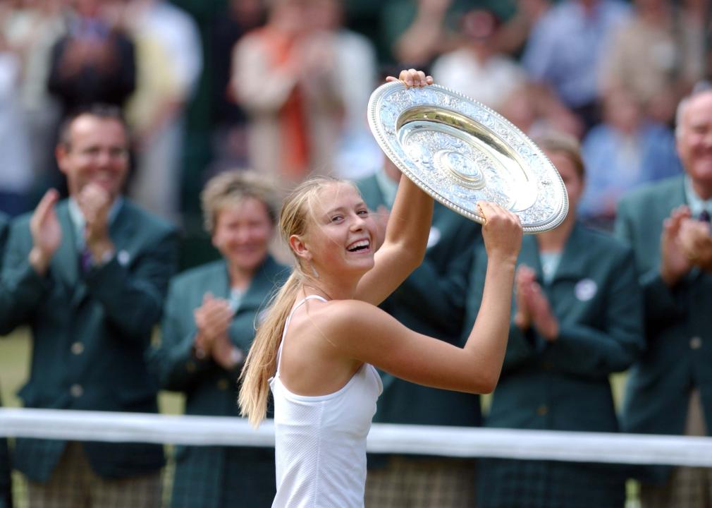 Maria Sharapova celebrates with the trophy at Wimbledon 2004.