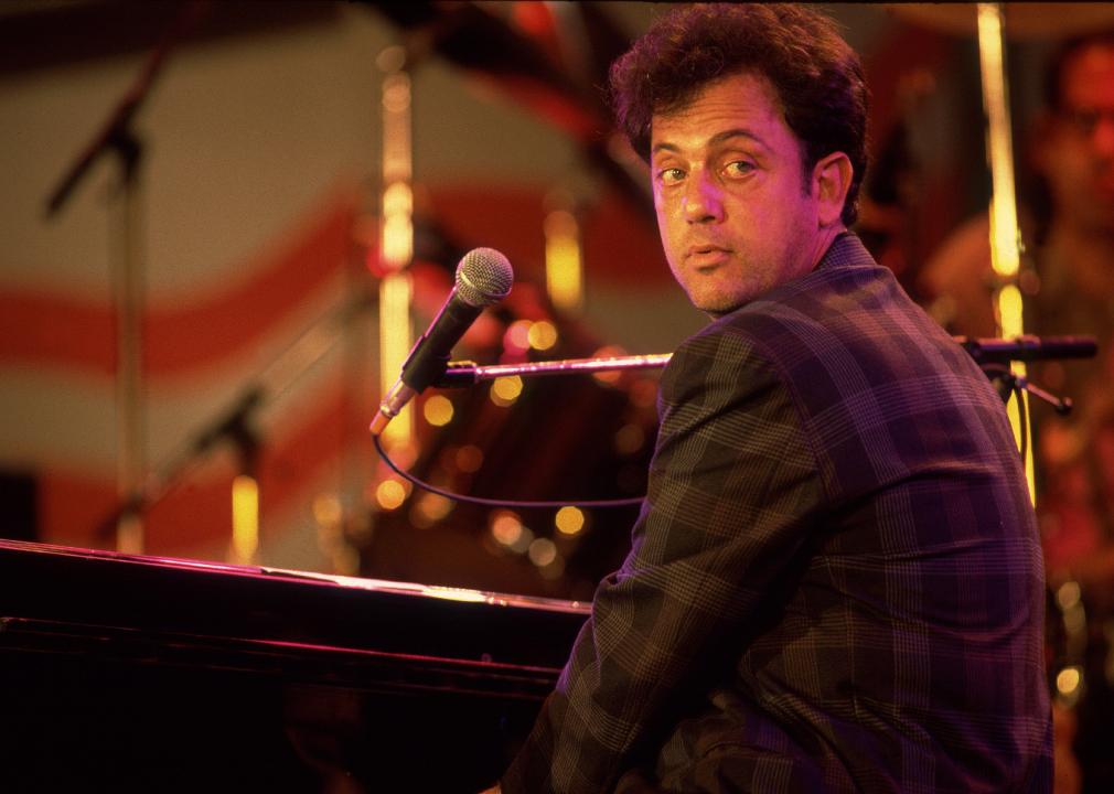 Billy Joel performs onstage during the first Farm Aid benefit concert.