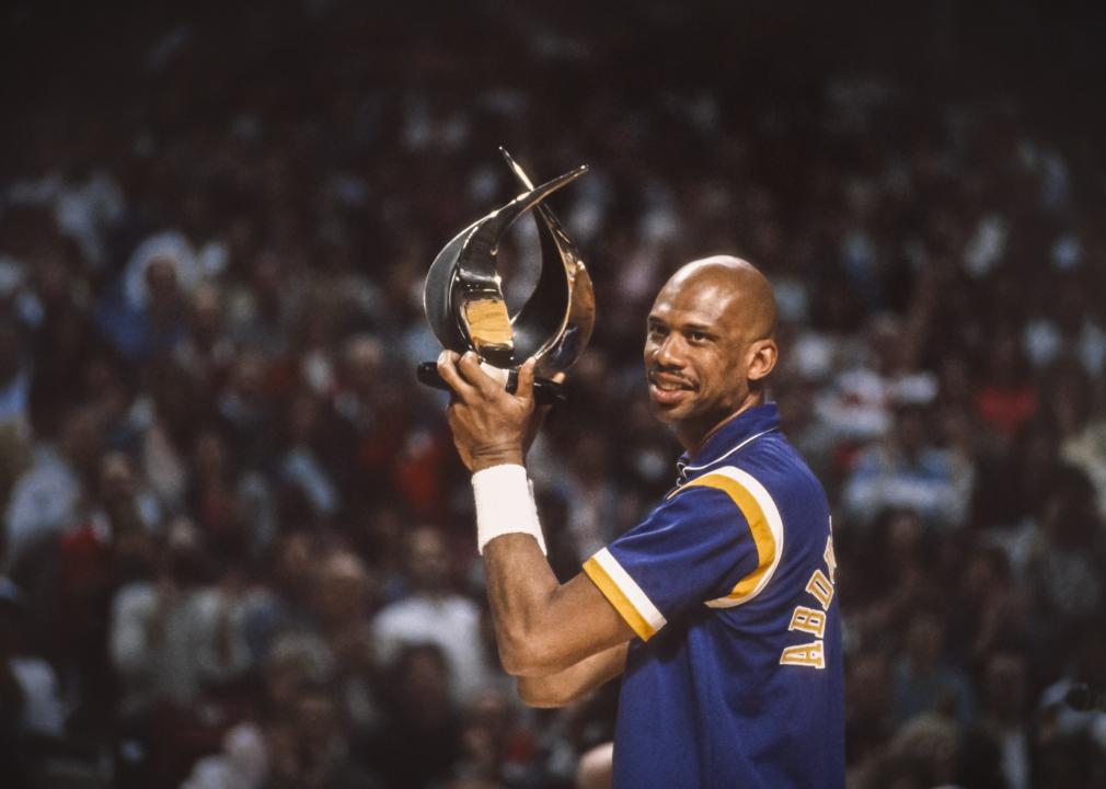 Kareem Abdul-Jabbar holds a trophy