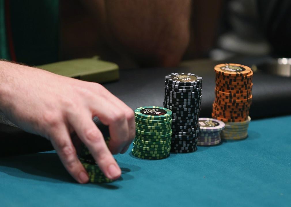 A poker player holds a stack of his chips.