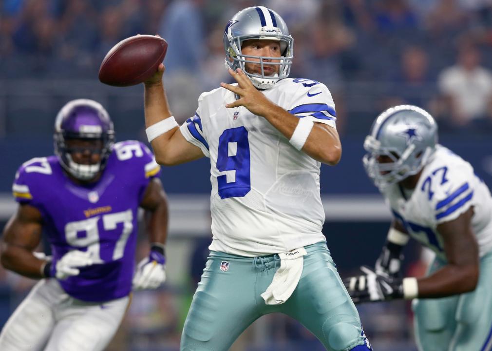 Tony Romo #9 of the Dallas Cowboys looks for an open receiver under pressure.