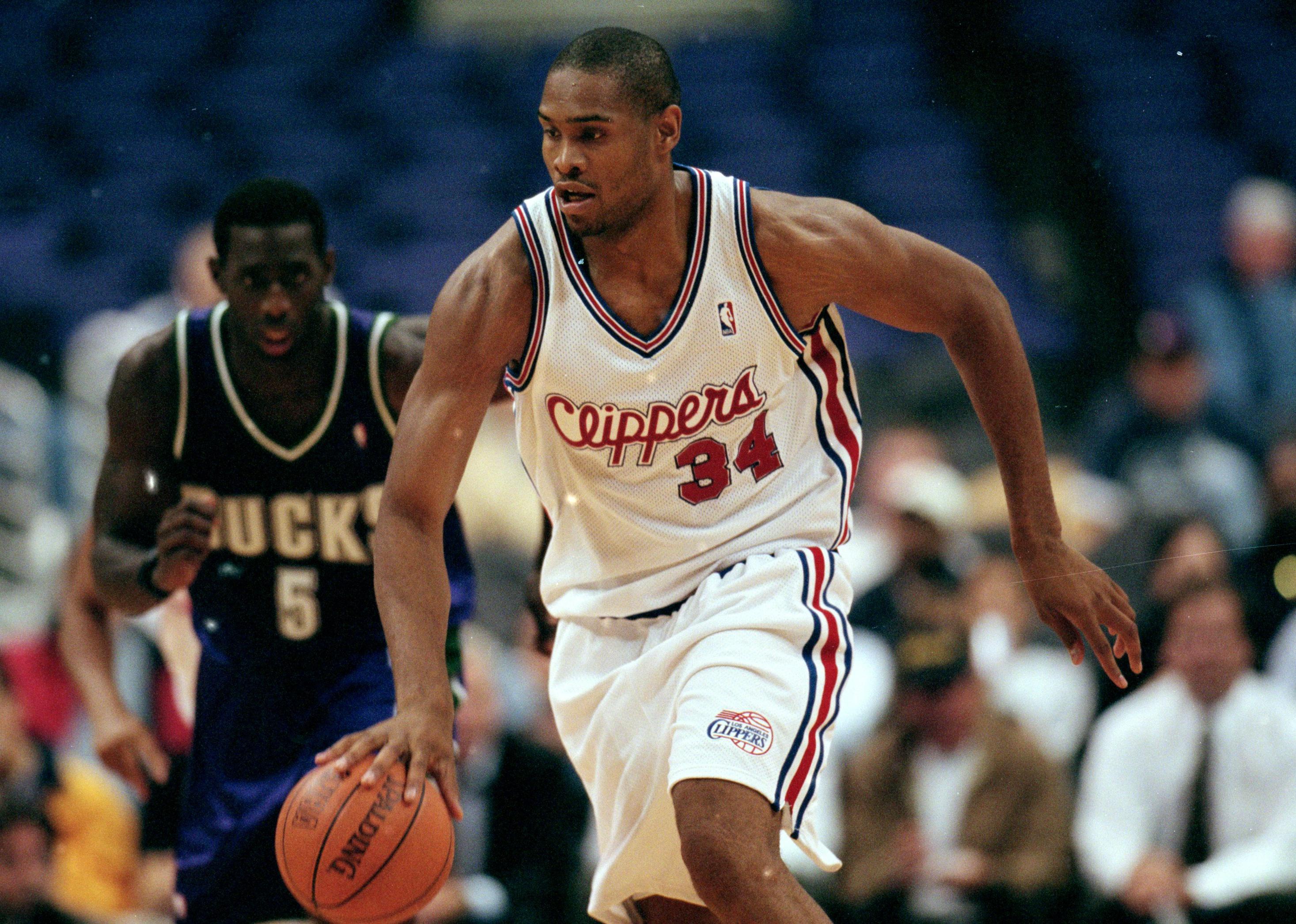 Michael Olowokandi dribbles the ball during a game at the Staples Center.
