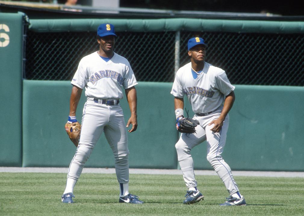 Ken Griffey Jr. and his father, Ken Griffey Sr. of the Seattle Mariners, stand together in the outfield.