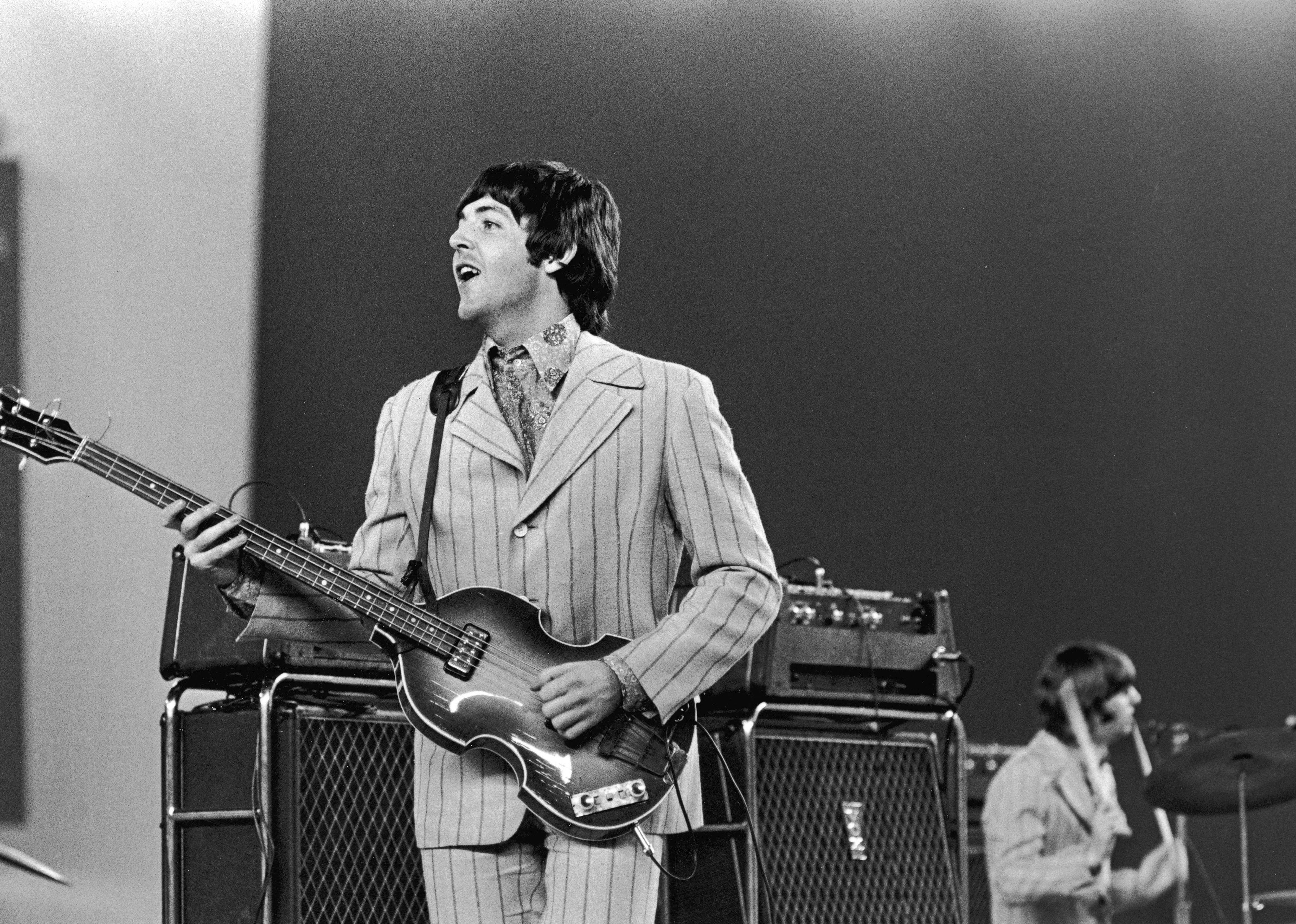 The Beatles performing onstage.
